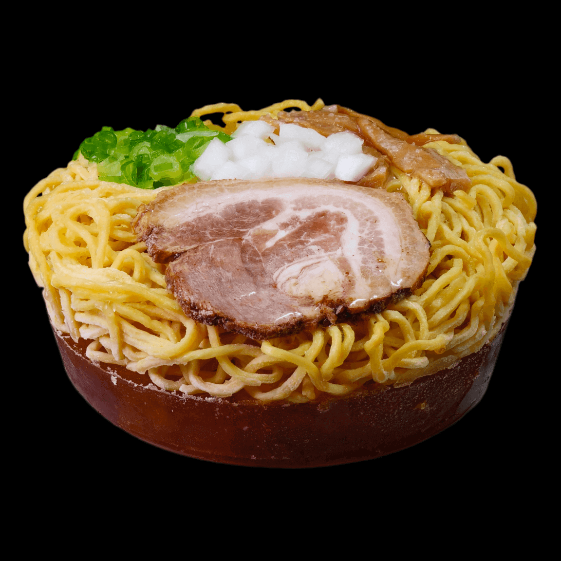 Bowl of Umami Shoyu Ramen with soy broth and tender pork belly cha-shu on dark background